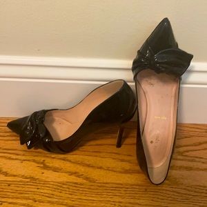 Patent Kate Spade Heels with swooshy patent side bow.